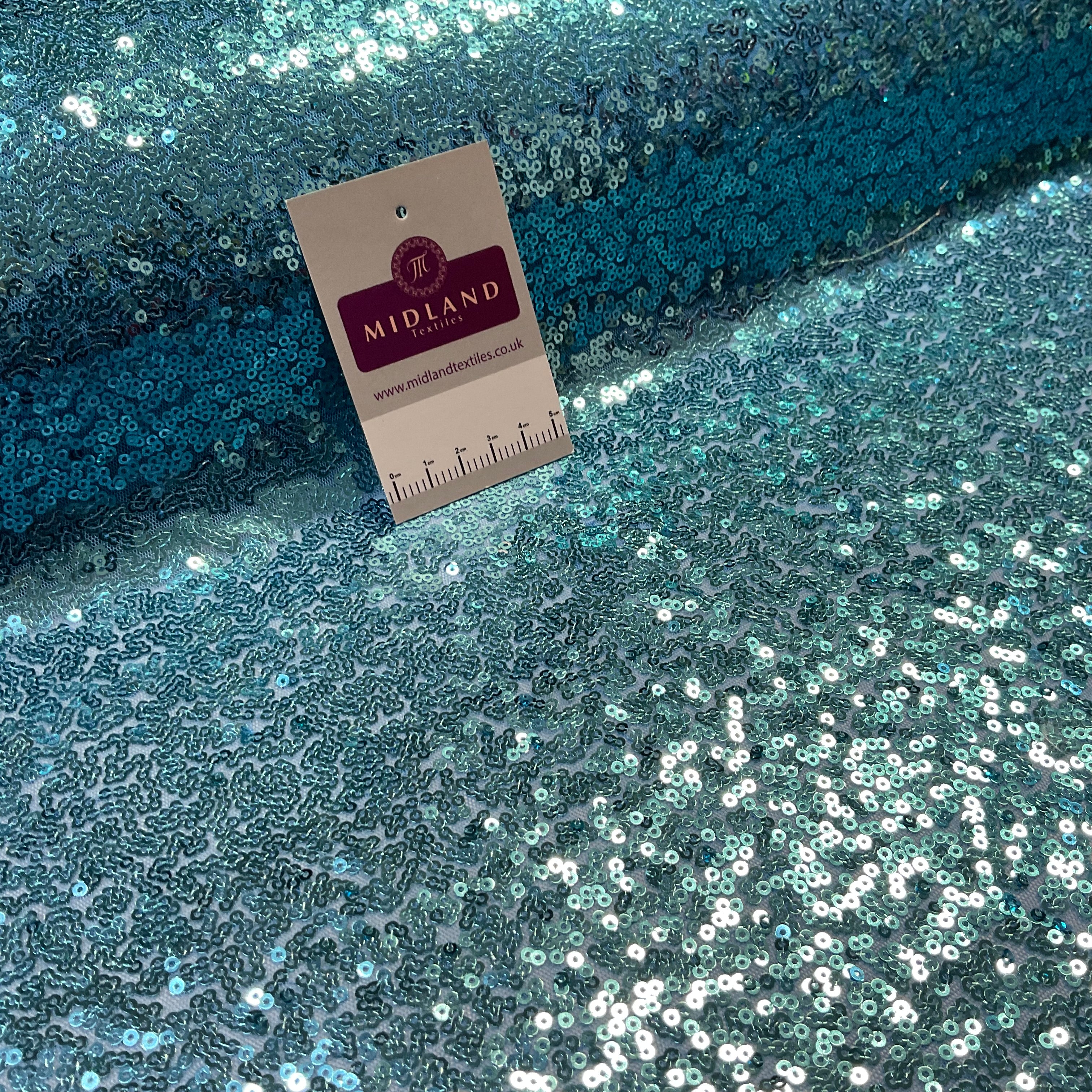 SENSATIONAL 3MM SEW ON ALL OVER SEQUINS ON NET FABRIC 50