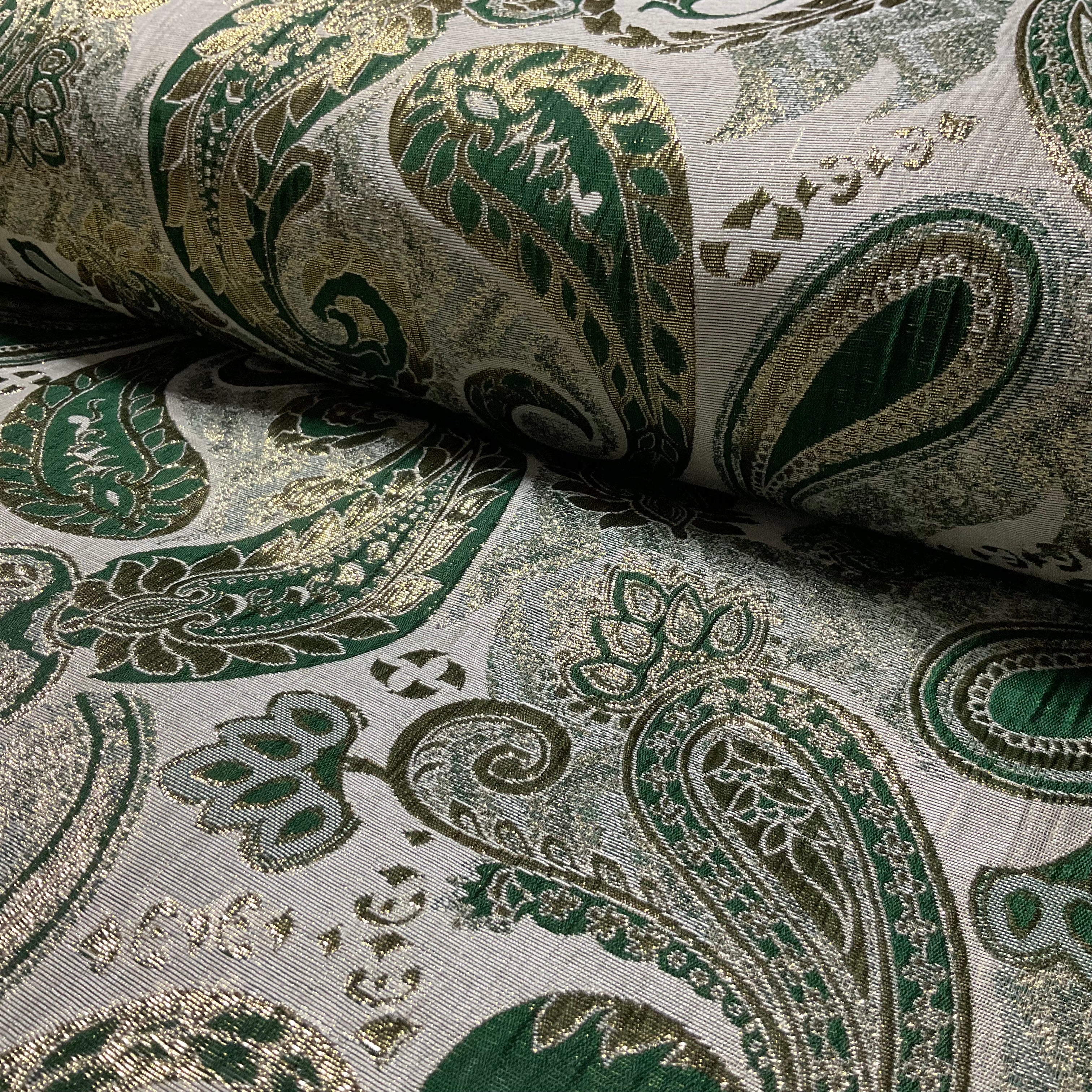 Close-up of green and gold paisley patterned fabric
