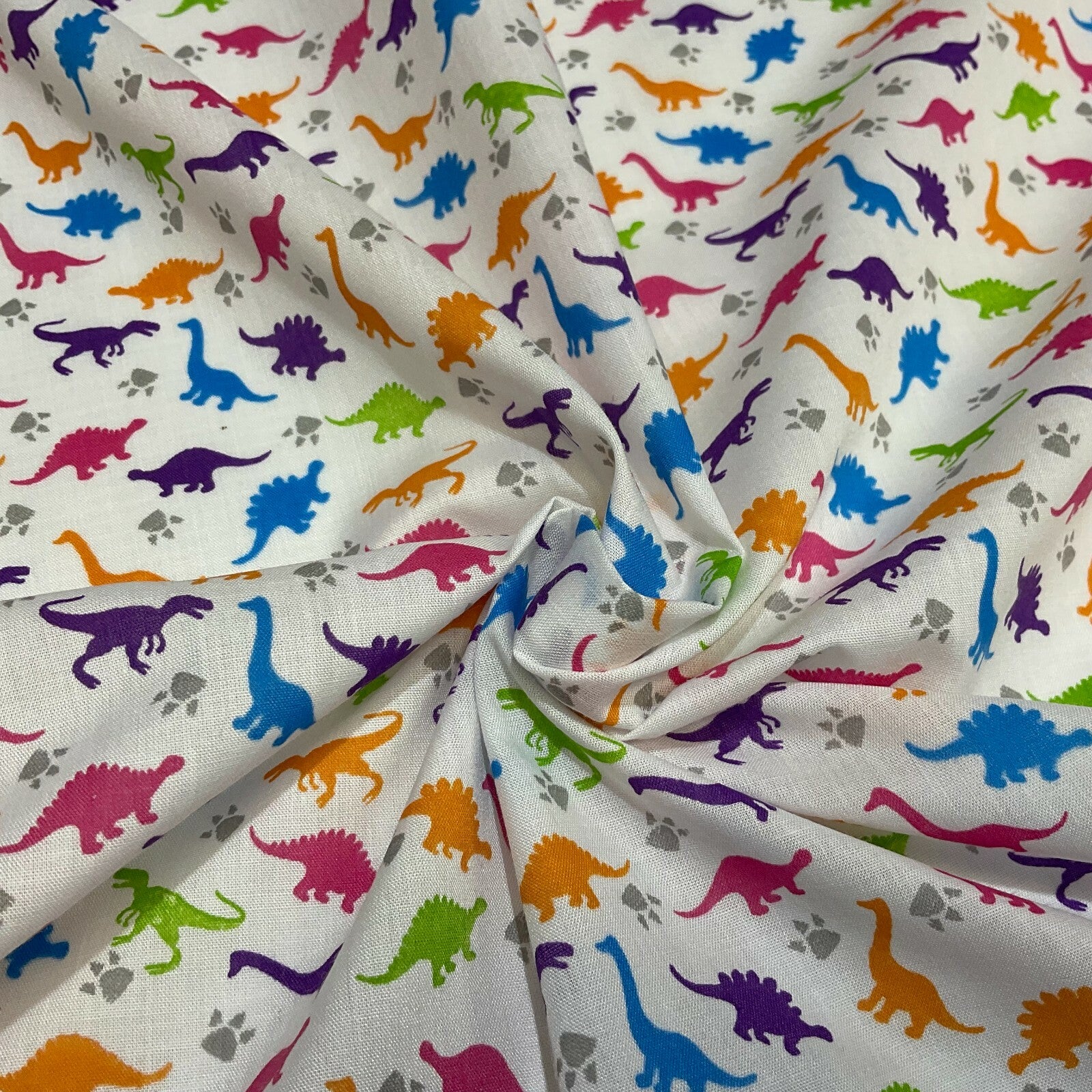 £2.50/m White Tiny Dinosaurs  Children's Poly cotton printed fabric M1637
