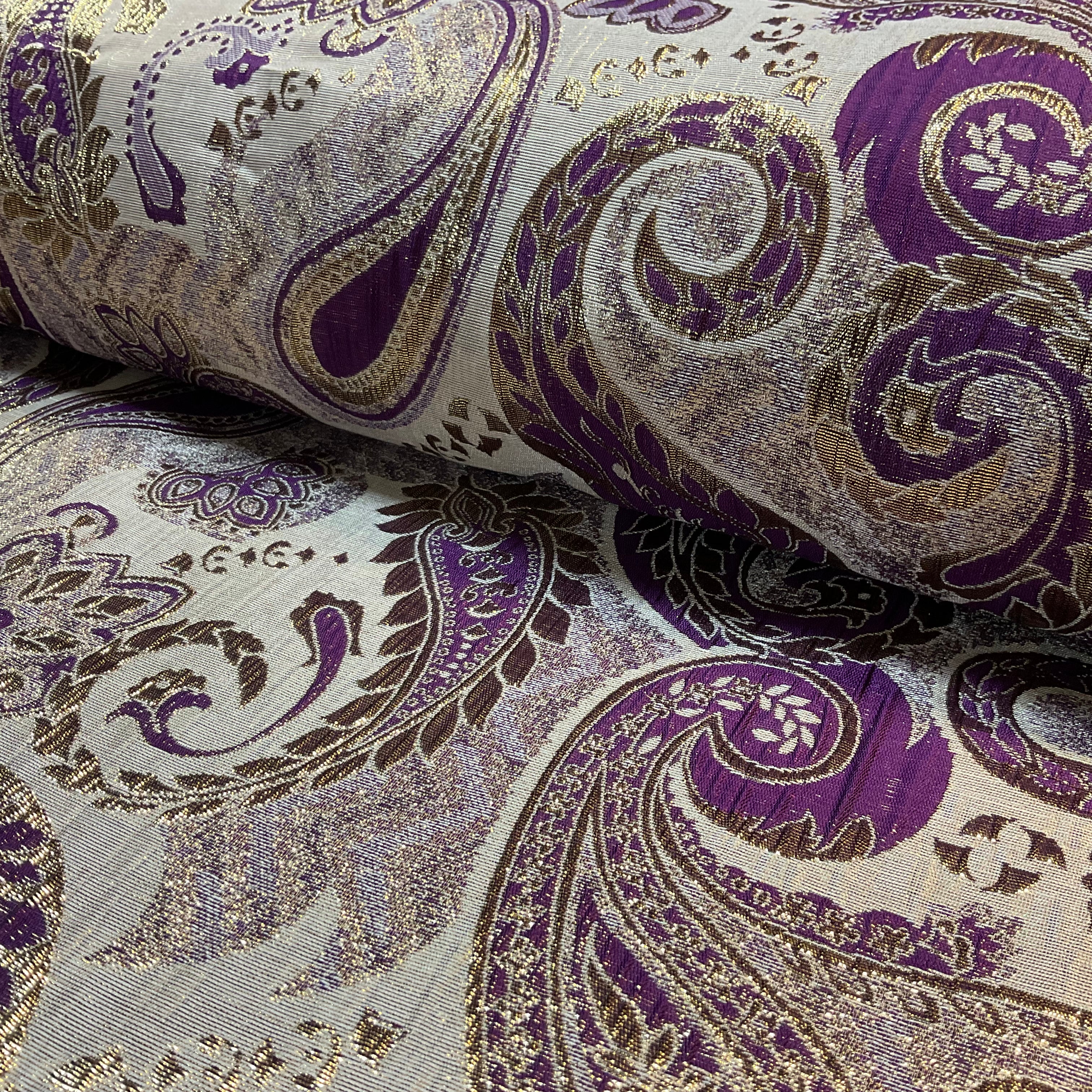 Close-up of purple and gold paisley patterned fabric