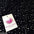 Black fabric with glittering sequins, ideal for dressmaking and crafts, featuring a Midland Textiles tag.