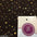 Black fabric with gold sequins and iridescent dots, ideal for dressmaking and crafts