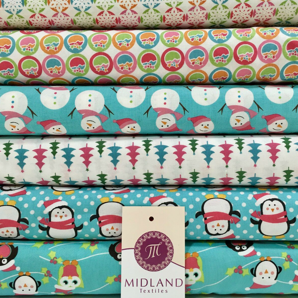 Stack of various 100% cotton fabrics with Christmas themed patterns including snowmen and penguins on a blue background.